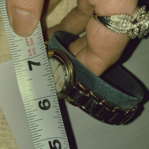 Citizens women's Eco-Drive watch with a pearl face and gold trim and a gold hand - Picture 13 of 13